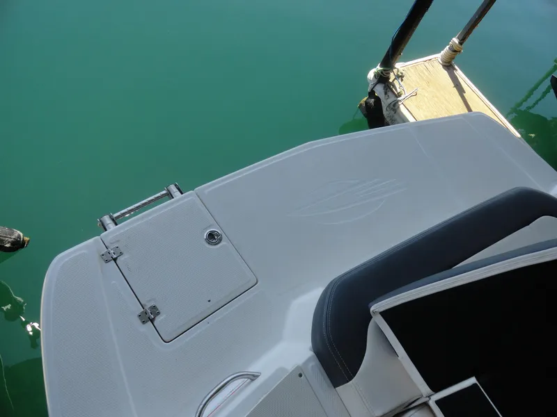 Slide: The Image of 2020 Chaparral 23 SSi boat stern platform near dock, with ladder and seating. - 20