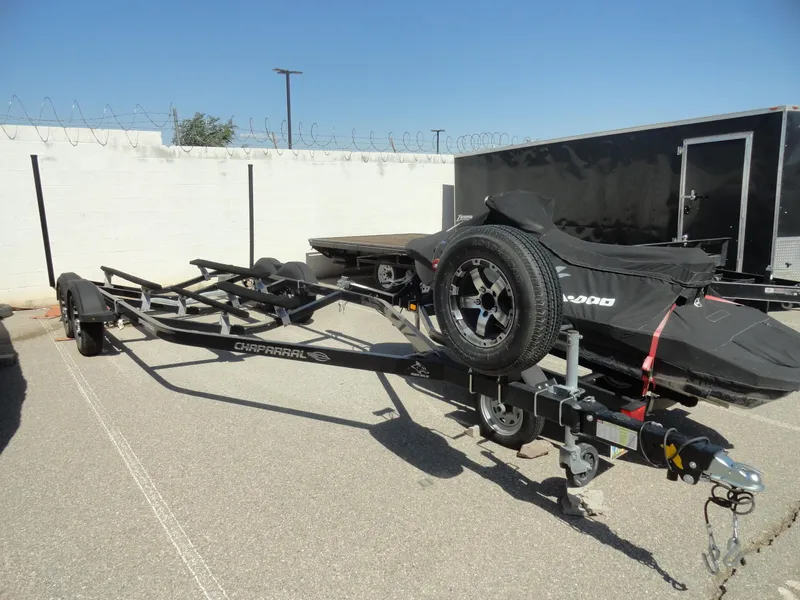 Slide: The Image of Trailer for 2020 Chaparral 23 SSi boat parked outdoors. - 24
