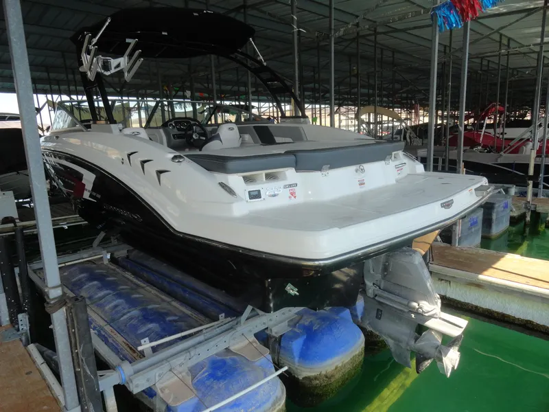 Slide: The Image of 2020 Chaparral 23 SSi boat docked in a covered marina. - 5