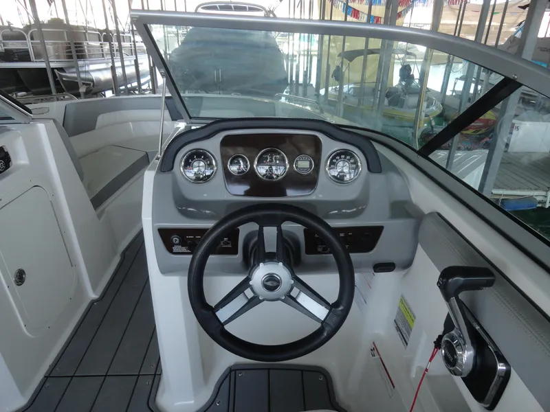 Slide: The Image of 2020 Chaparral 23 SSi boat dashboard with steering wheel and controls. - 8