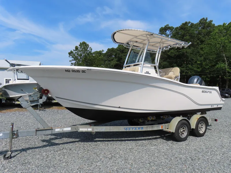 Slide: The Image of 2018 Sea Fox 226 Commander boat on trailer, parked outdoors. - 0