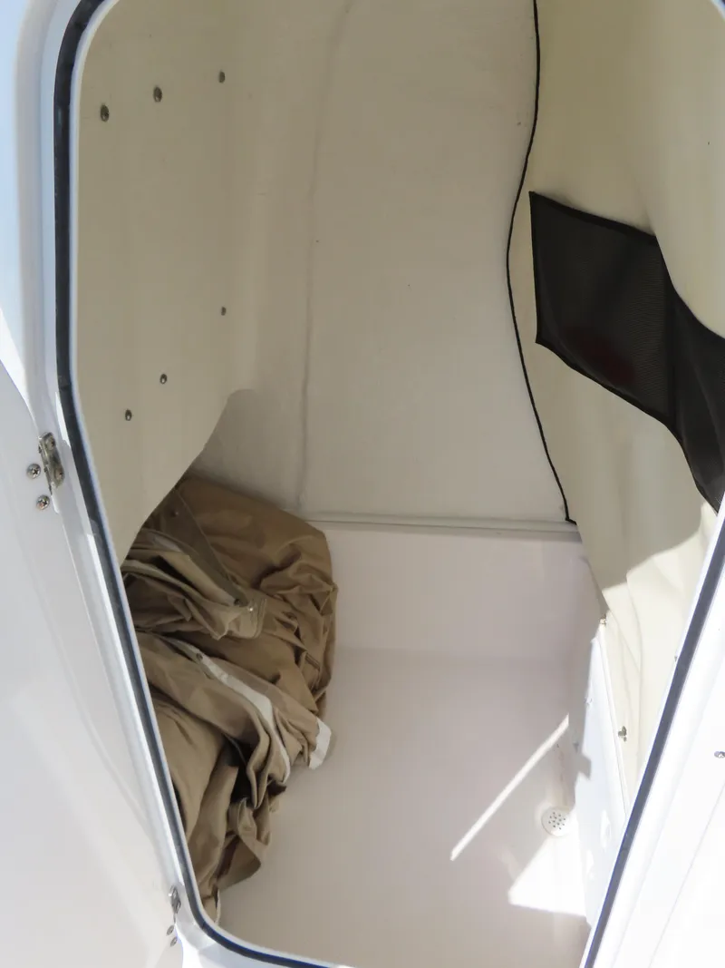 Slide: The Image of Storage compartment of 2018 Sea Fox 226 Commander boat, featuring beige fabric and black netting. - 20