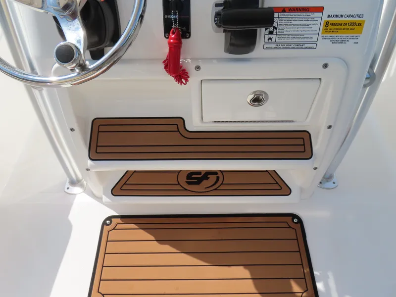 Slide: The Image of 2018 Sea Fox 226 Commander boat console with steering wheel and control panel. - 27