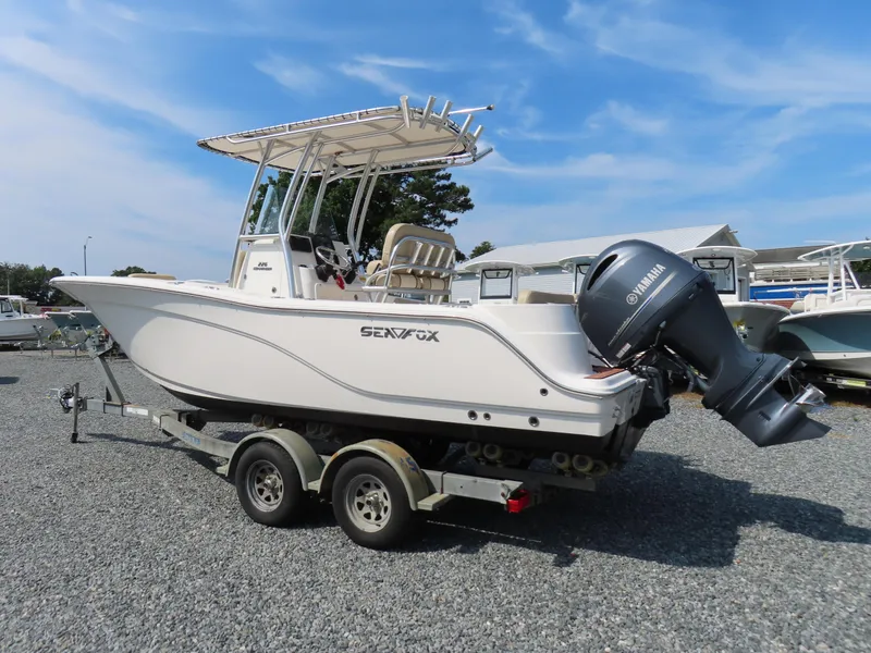 Slide: The Image of 2018 Sea Fox 226 Commander boat on trailer, featuring Yamaha outboard motor, parked outdoors. - 3