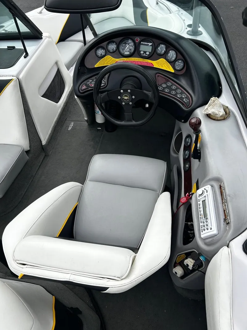 Slide: The Image of 2000 Correct Craft Air Nautique boat interior with steering wheel and dashboard controls. - 9