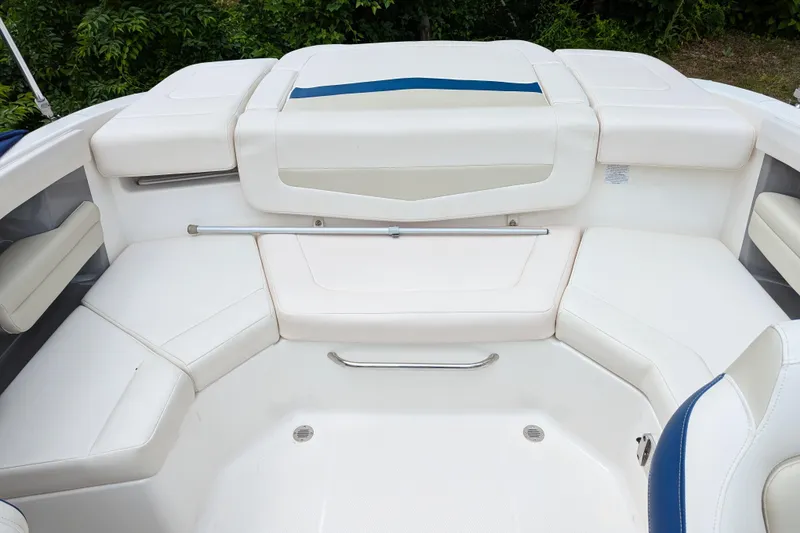 Slide: The Image of 2016 Chaparral 216 SSi boat interior with white cushioned seating and sleek design. - 2