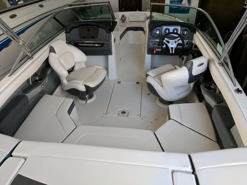 Slide: The Image of 2016 Chaparral 216 SSi boat interior with seating and steering console. - 3