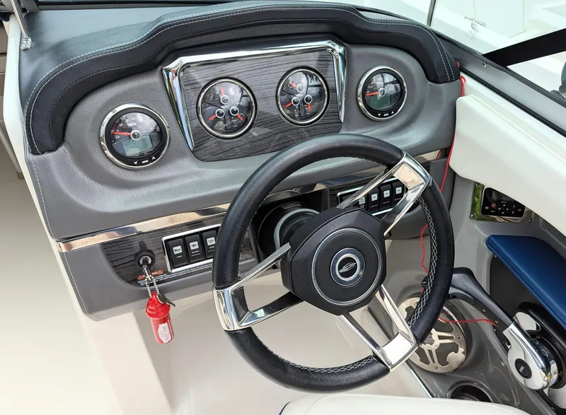 Slide: The Image of 2016 Chaparral 216 SSi boat dashboard with steering wheel and gauges. - 5