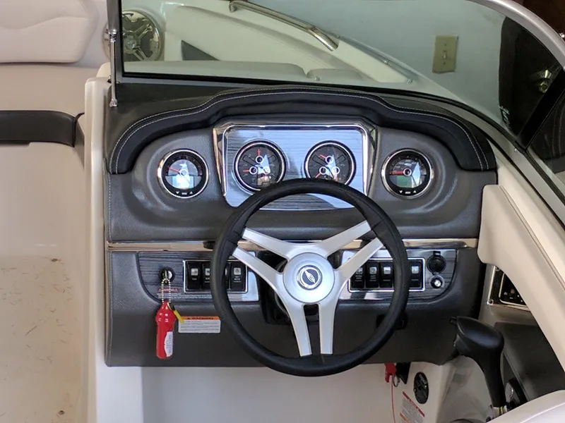 Slide: The Image of 2016 Chaparral 216 SSi boat dashboard with steering wheel and gauges. - 6