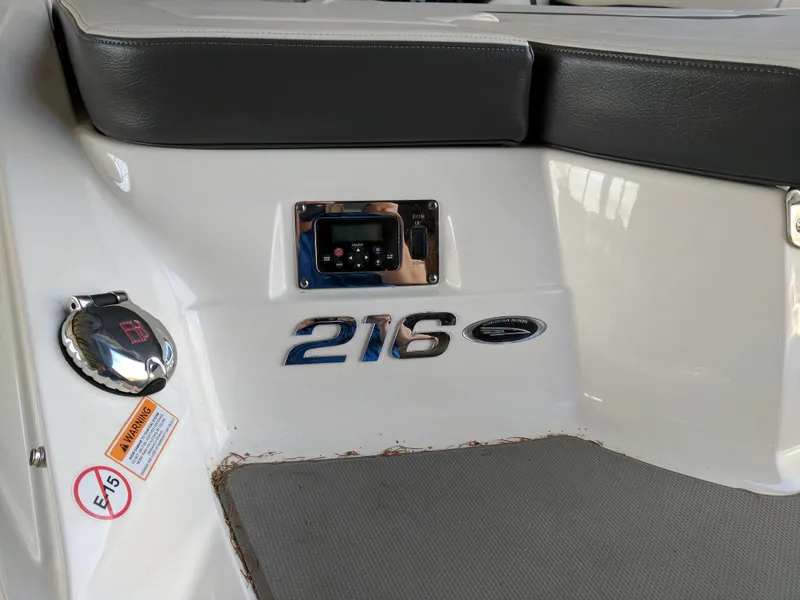 Slide: The Image of 2016 Chaparral 216 SSi boat interior with seating and model emblem. - 8
