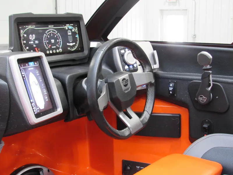 Slide: The Image of 2021 Malibu Wakesetter 22 LSV dashboard with digital displays and steering wheel. - 12