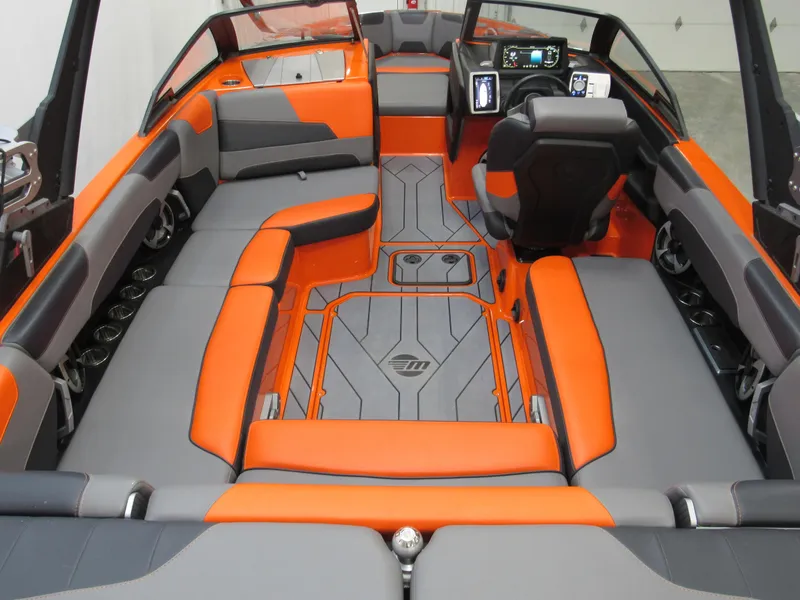 Slide: The Image of 2021 Malibu Wakesetter 22 LSV interior with orange and gray seating, modern dashboard. - 3