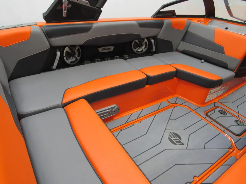 Slide: The Image of 2021 Malibu Wakesetter 22 LSV interior with orange and gray seating and flooring. - 5