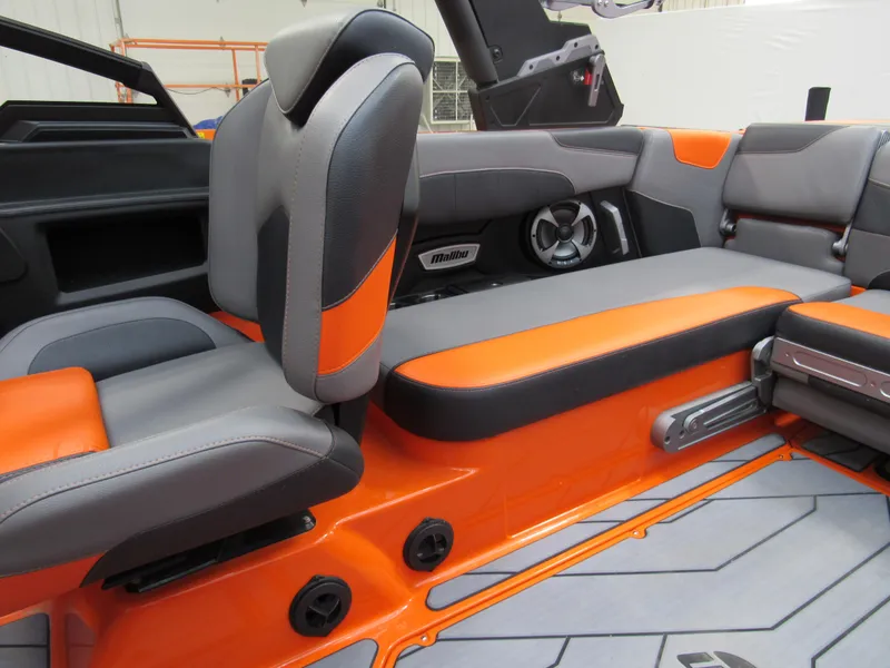 Slide: The Image of 2021 Malibu Wakesetter 22 LSV interior with orange and gray seating, featuring premium audio system. - 6