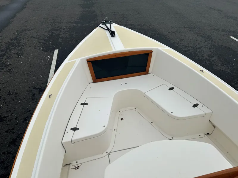 Slide: The Image of 2014 Nantucket Boat Works 17 Skiff interior with storage compartments, parked on asphalt. - 13