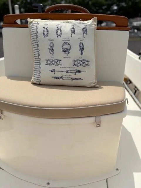 Slide: The Image of Cushioned seat on 2014 Nantucket Boat Works 17 Skiff with nautical-themed pillow. - 16