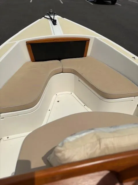 Slide: The Image of 2014 Nantucket Boat Works 17 Skiff with beige seating in a parking lot. - 18