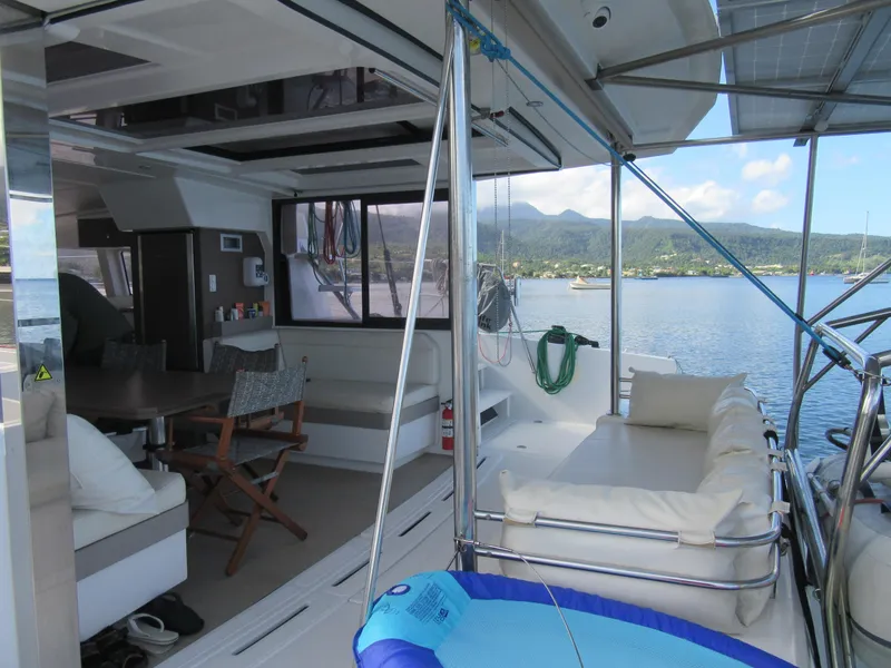 Slide: The Image of Luxurious Bali 4.1 catamaran interior with seating, table, and scenic ocean view, 2020 model. - 11