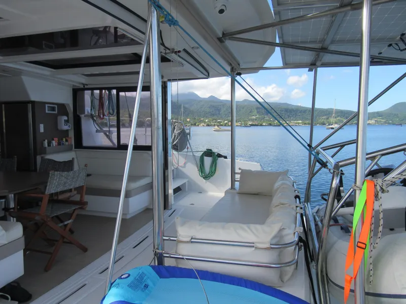 Slide: The Image of Luxurious Bali 4.1 catamaran interior with scenic ocean view, featuring comfortable seating, 2020 model. - 12