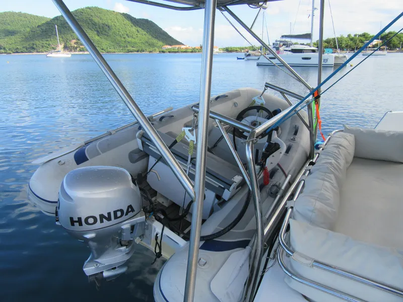 Slide: The Image of Inflatable boat with Honda motor on Bali 4.1, 2020 model, docked in scenic bay. - 16