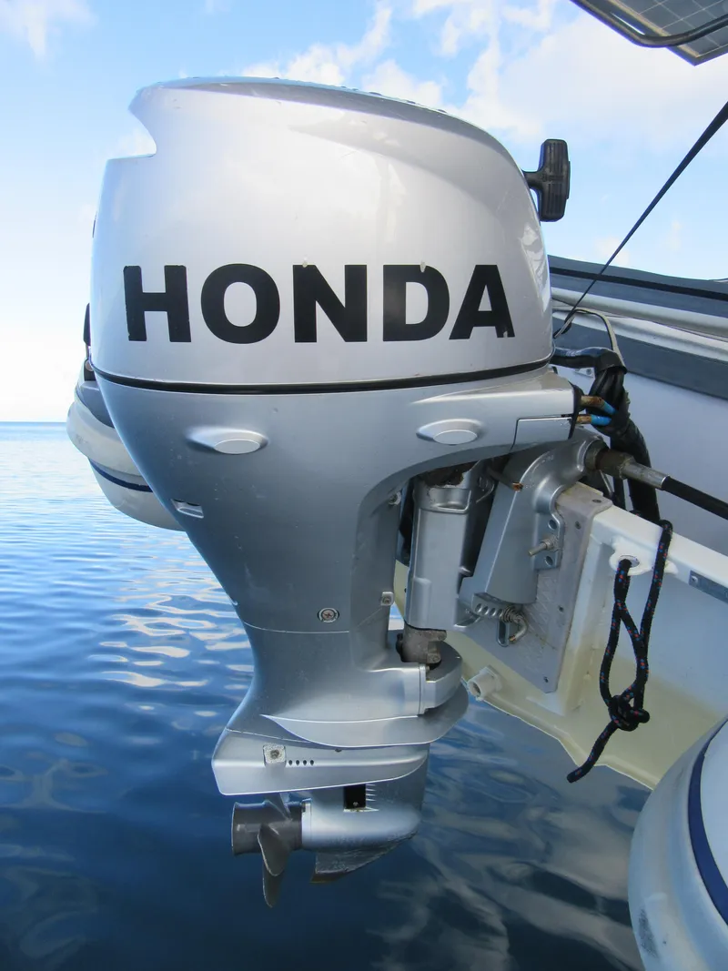 Slide: The Image of Silver Honda outboard motor on a Bali 4.1 boat, 2020 model, against a calm sea backdrop. - 19