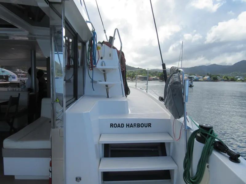 Slide: The Image of Bali 4.1 catamaran docked at Road Harbour, 2020 model, with scenic coastal view. - 21