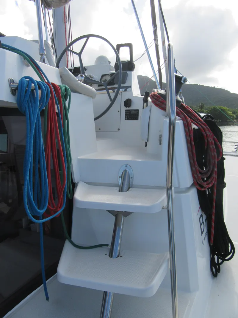 Slide: The Image of Steering area of a 2020 Bali 4.1 catamaran with colorful ropes and steps. - 22