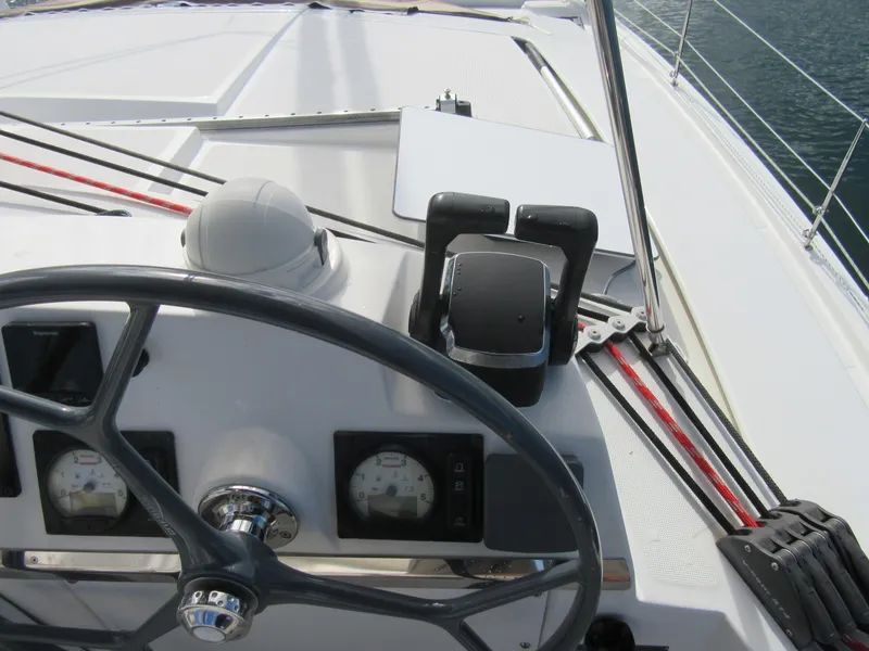 Slide: The Image of Steering wheel and controls of a 2020 Bali 4.1 yacht, featuring navigation instruments. - 25