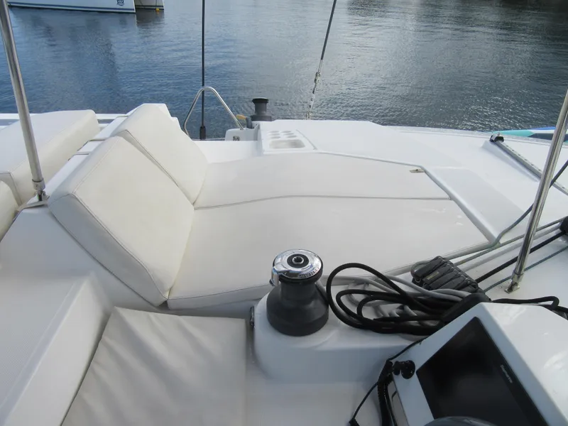 Slide: The Image of Luxurious Bali 4.1 catamaran deck with comfortable seating, winch, and navigation equipment, 2020 model. - 28