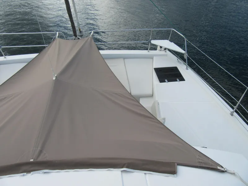 Slide: The Image of Bali 4.1 catamaran deck with sunshade, 2020 model, on calm water. - 36