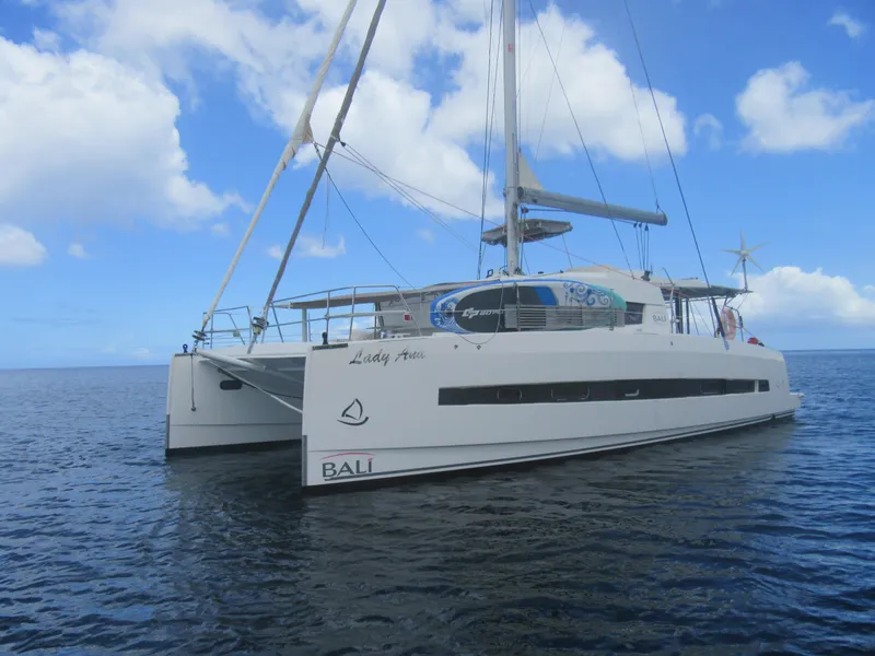 Slide: The Image of Sailing catamaran Bali 4.1, 2020 model, on calm ocean under blue sky. - 4