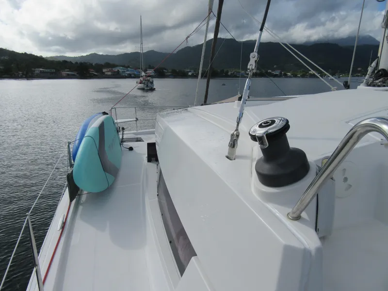 Slide: The Image of Sailboat deck view with paddleboard, Bali 4.1 model, anchored in scenic bay. - 40