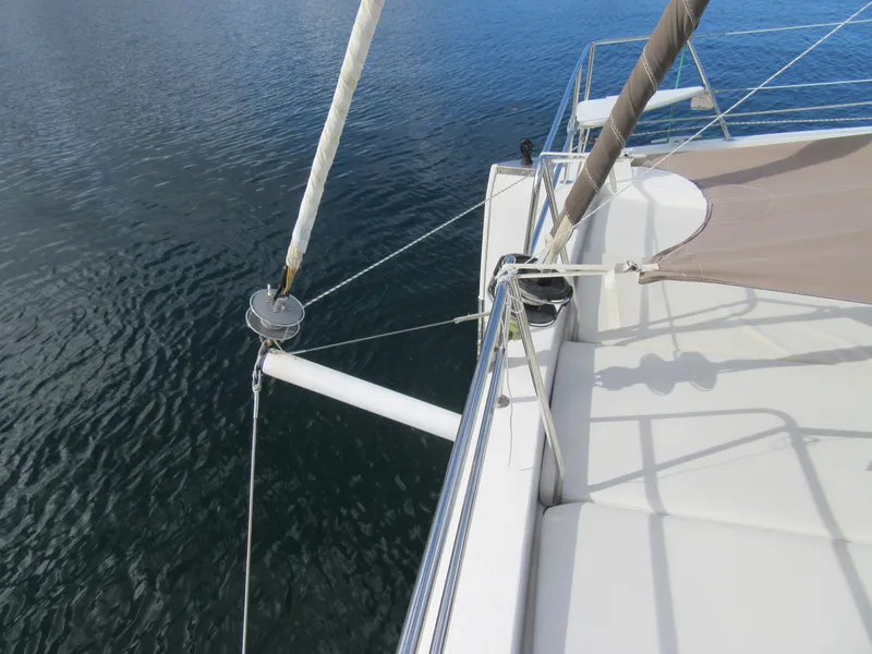 Slide: The Image of Bali 4.1 catamaran deck view, 2020 model, with sail rigging over calm water. - 42