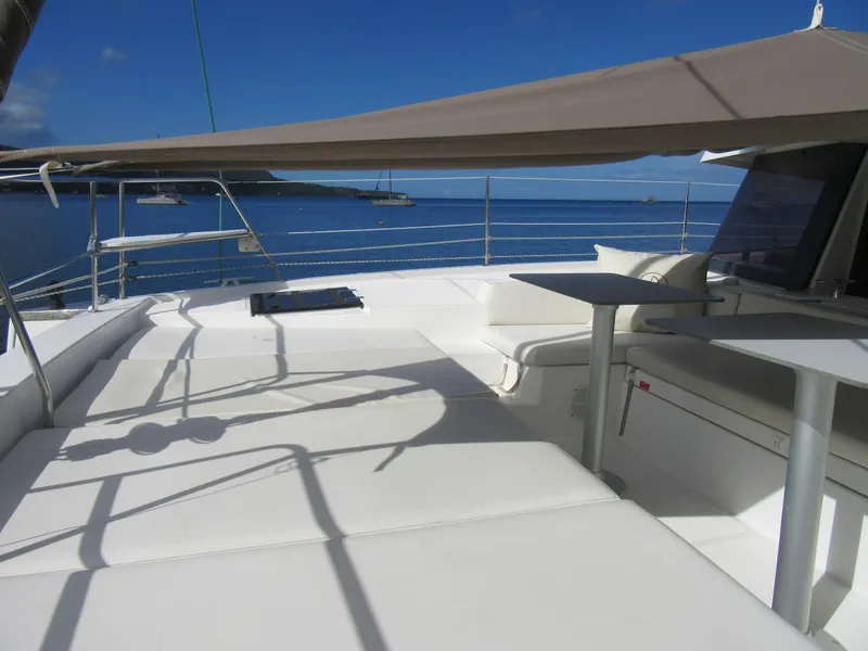Slide: The Image of Luxurious Bali 4.1 catamaran deck with seating, table, and ocean view, 2020 model. - 45