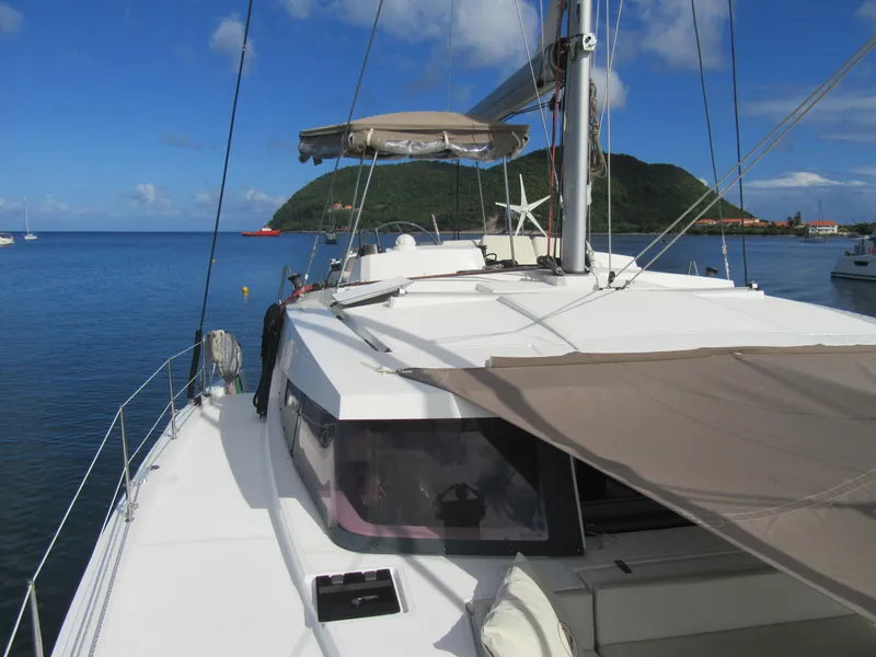 Slide: The Image of Sailing catamaran Bali 4.1, 2020 model, anchored in scenic bay with lush hills. - 46