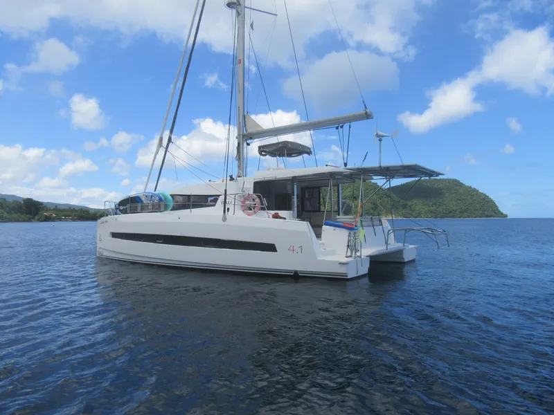 Slide: The Image of Bali 4.1 catamaran sailing on calm waters, 2020 model, under a clear blue sky. - 5