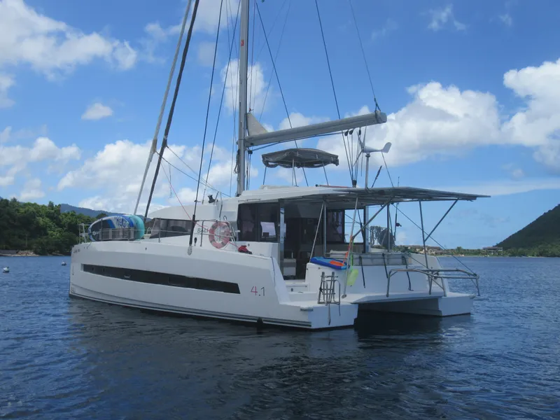Slide: The Image of Bali 4.1 catamaran sailing on calm waters, 2020 model, under a clear blue sky. - 7