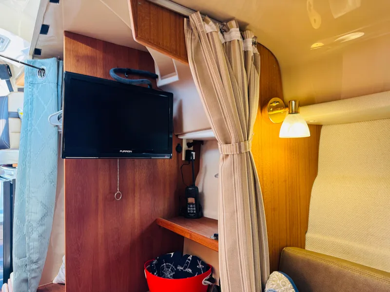 Slide: The Image of Interior of 2018 Ranger Tugs R-27 with TV, curtain, and cozy lighting. - 10