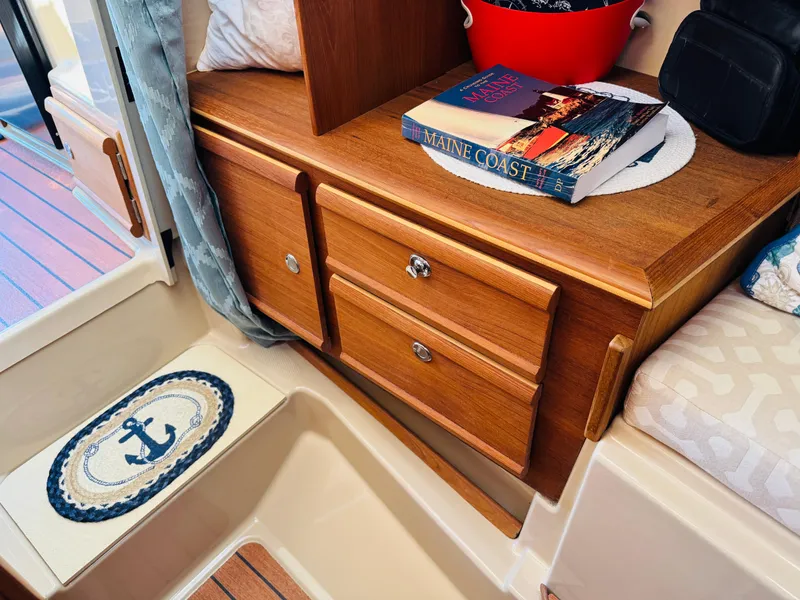 Slide: The Image of Interior of 2018 Ranger Tugs R-27 with wooden cabinetry and nautical decor. - 11