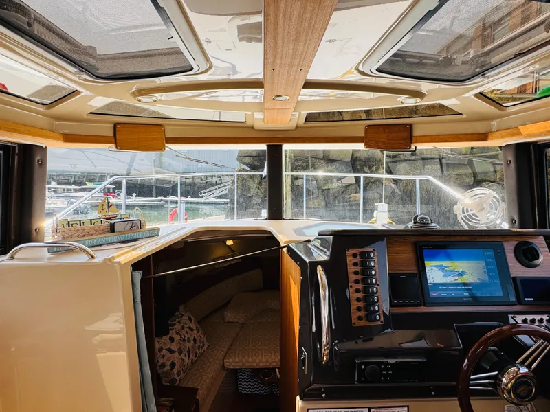 Slide: The Image of Interior view of 2018 Ranger Tugs R-27 boat with navigation system and cozy cabin. - 17