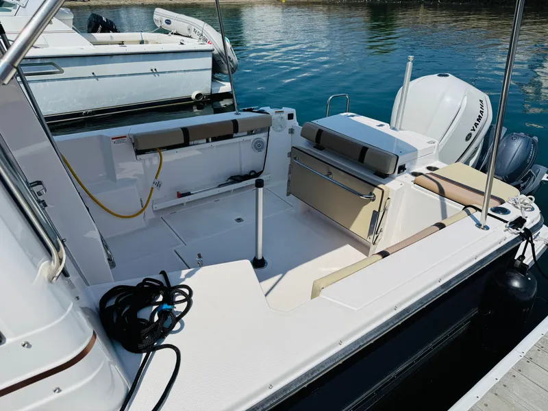 Slide: The Image of 2018 Ranger Tugs R-27 boat interior with Yamaha engine, docked at marina. - 27