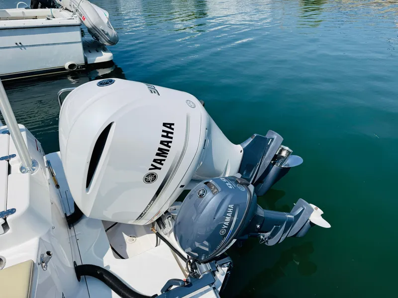 Slide: The Image of Yamaha outboard motors on a 2018 Ranger Tugs R-27 boat in a marina. - 33