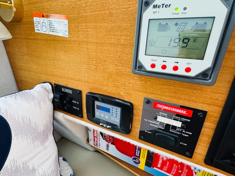 Slide: The Image of Control panel of a 2018 Ranger Tugs R-27 boat with various gauges and switches. - 40