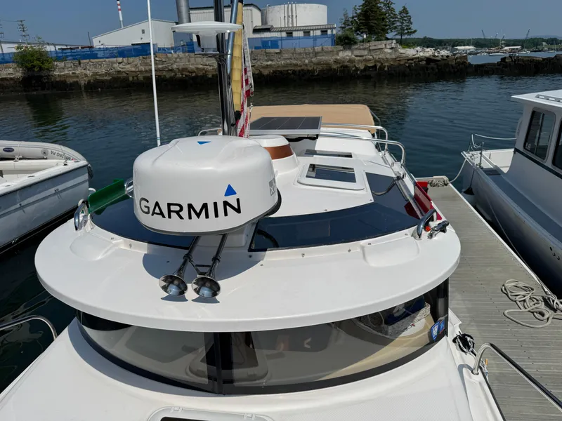 Slide: The Image of 2018 Ranger Tugs R-27 boat docked, featuring Garmin equipment on the roof. - 44