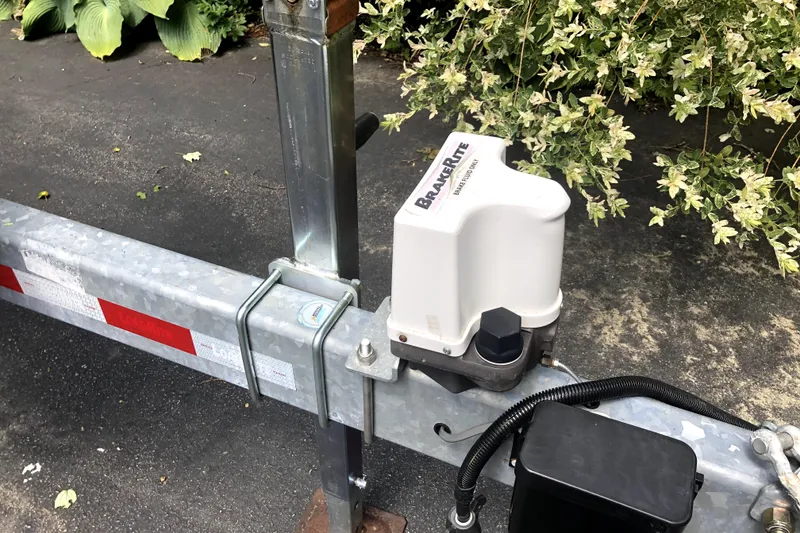 Slide: The Image of Trailer brake actuator on a Ranger Tugs R-27, 2018 model, parked on asphalt. - 48