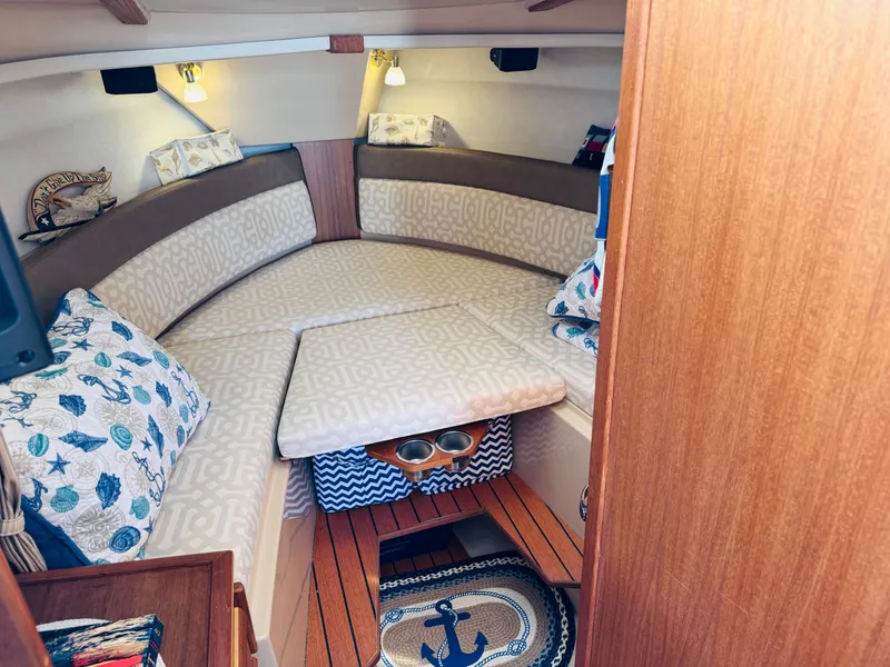 Slide: The Image of 2018 Ranger Tugs R-27 cabin interior with cozy bedding and nautical decor. - 9