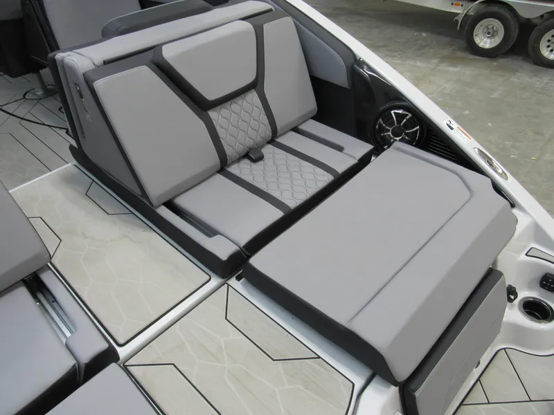 Slide: The Image of 2024 Yamaha Boats 255XD interior seating with modern gray upholstery and sleek design. - 14