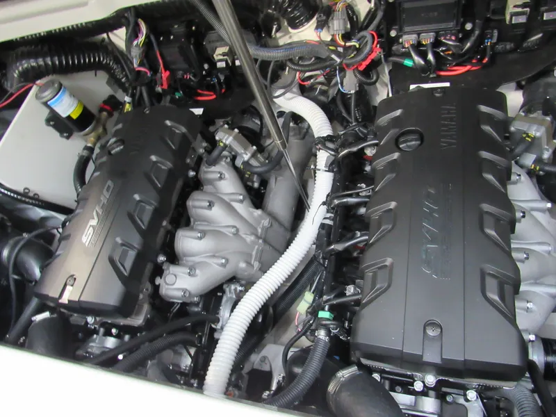 Slide: The Image of 2024 Yamaha Boats 255XD engine compartment with dual SVHO engines and complex wiring. - 17