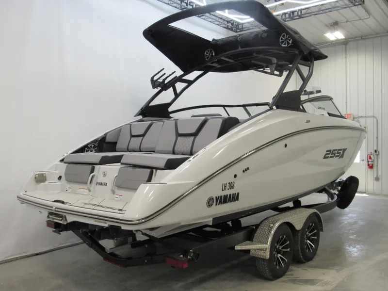 Slide: The Image of 2024 Yamaha Boats 255XD on trailer in indoor showroom. - 2