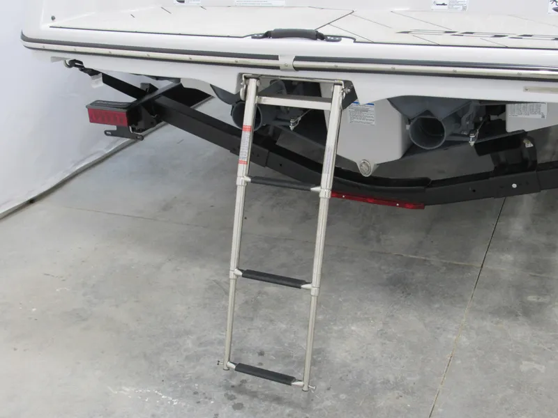 Slide: The Image of 2024 Yamaha Boats 255XD with extended swim ladder on trailer. - 3